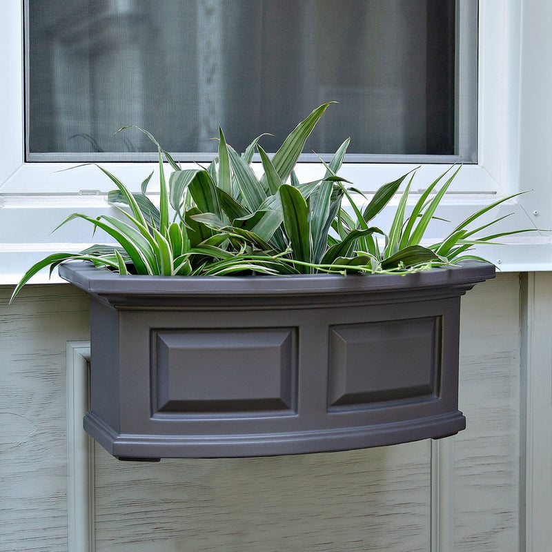 The Mayne Nantucket 2ft Window Box Planter, in the graphite finish,planted and mounted on home for curb appeal