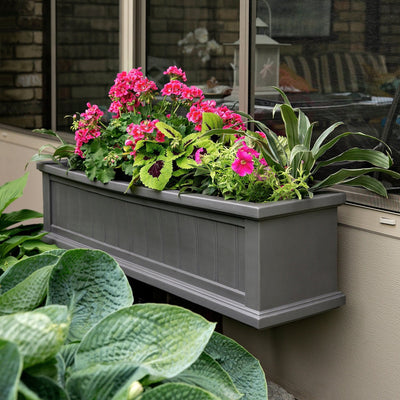 The Mayne Cape Cod 4ft Window Box, in the graphite finish,planted and mounted on home for curb appeal