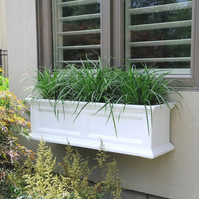 The Mayne Fairfield 3ft Window Box Planter, in the white finish, planted and mounted on home for curb appeal