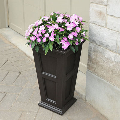 The Mayne Fairfield Tall Planter, in the espresso finish, planted and placed near home for curb appeal.