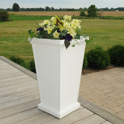 The Mayne Wellington Tall Planter, in the white finish, simply planted with flowers to accent a deck in the country
