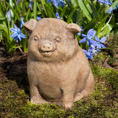 Campania International Piglet Statue, set in the garden to add charm and character. The statue is shown in the Brownstone Patina.