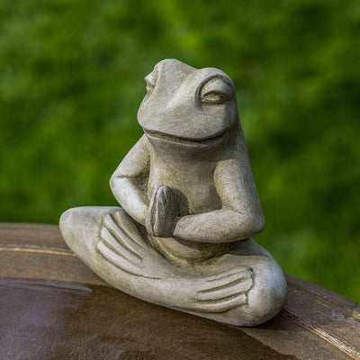 Campania International Meditation Frog Statue, set in the garden to add charm and character. The statue is shown in the English Moss Patina.