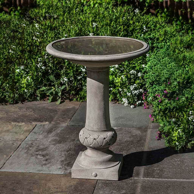 Campania International Williamsburg Knot Garden Birdbath, set in the garden to adding charm and purpose. The birdbath is shown in the Greystone Patina.