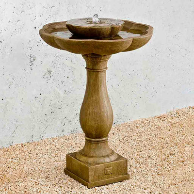 Campania International Flores Pedestal Fountain is made of cast stone by Campania International and shown in the  Aged Limestone Patina