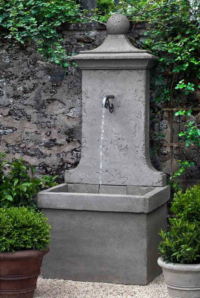 Campania International Vence Wall Fountain, adding interest to the garden with the sound of water. This fountain is shown in the Alpine Stone Patina.
