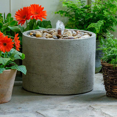 Campania International Salinas Low Pebble Fountain is made of cast stone by Campania International and shown in the Greystone Patina