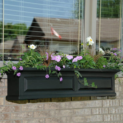 The Mayne Nantucket 4ft Window Box Planter, in the black finish, planted and mounted on home for curb appeal