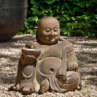 Campania International Abaca Buddha Garden Statue, set in the garden to adding charm an meaning. The statue is shown in the Pietra Nuova Patina.