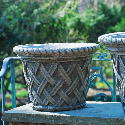 Campania International English Weave Medium Planter is shown in the Alpine Stone Patina. Made from cast stone.