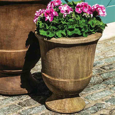 Campania International Pascal Small Urn is shown in the Age Limestone Patina. Made from cast stone.