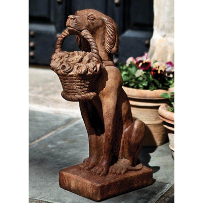 Campania International Vintage Dog with Basket Garden Dog Statue holds a basket of flowers to happily greet you at the front door or in the garden for years to come. Shown in the Pietra Nuovo.