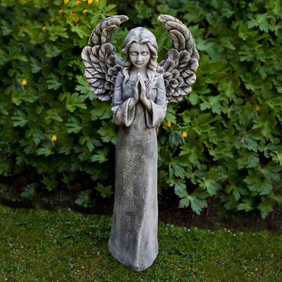 Campania International Fiona's Angel Statue placed in the garden. Religious garden statues, made of cast stone in a range of color options.