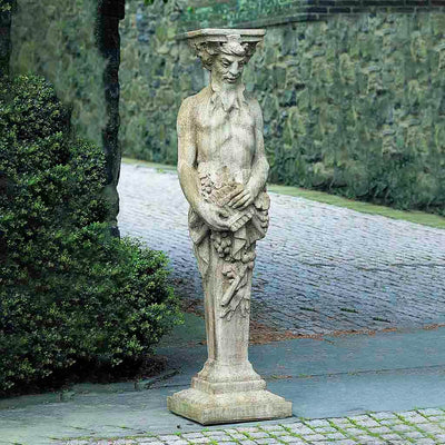 Campania International Tall Satyr Statue, set in the garden to add charm and character. The statue is shown in the Aged Limestone Patina.