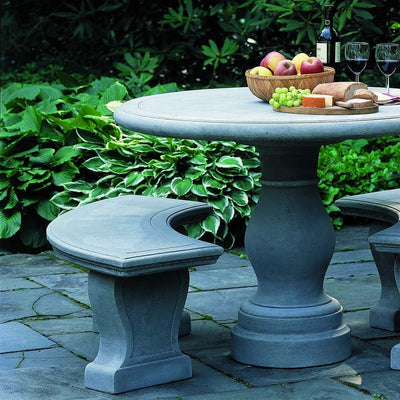 Campania International Palladio Bench, set in the garden to adding charm and purpose. The bench is shown in the Greystone Patina.
