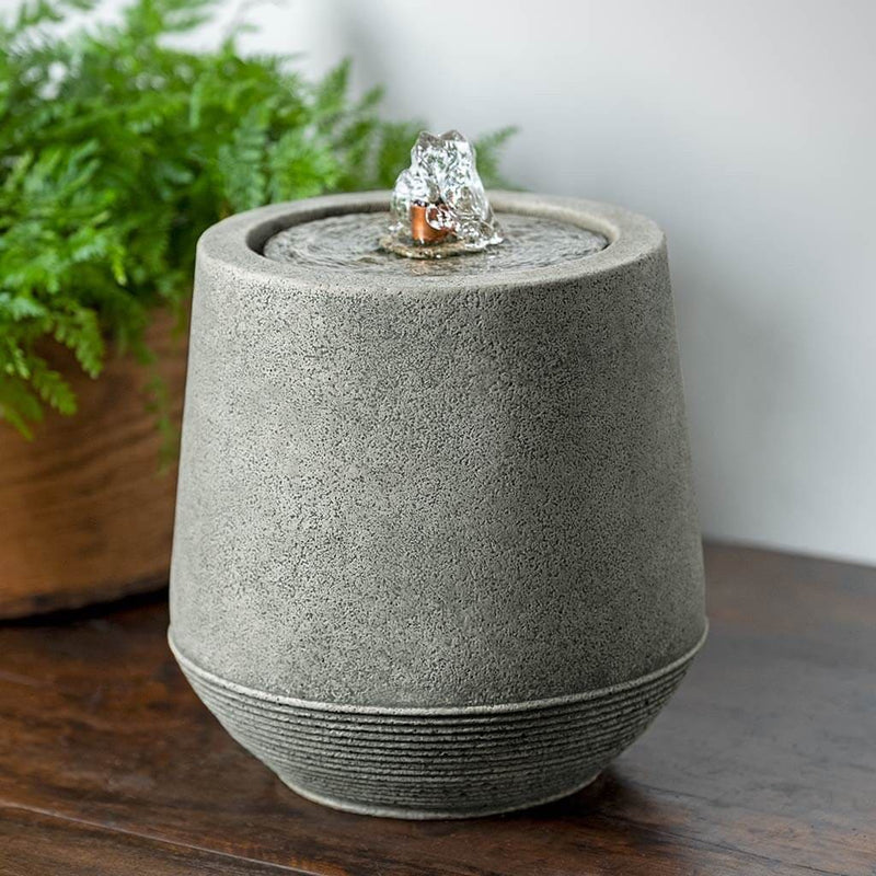 Campania International Mari Fountain  is stained in the Alpine Stone patina, showing off the details of the fountain.