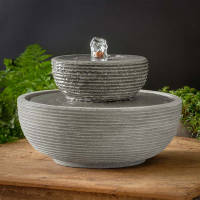 Campania International Ribbed Longport Fountain  is stained in the Alpine Stone patina, showing off the details of the fountain.