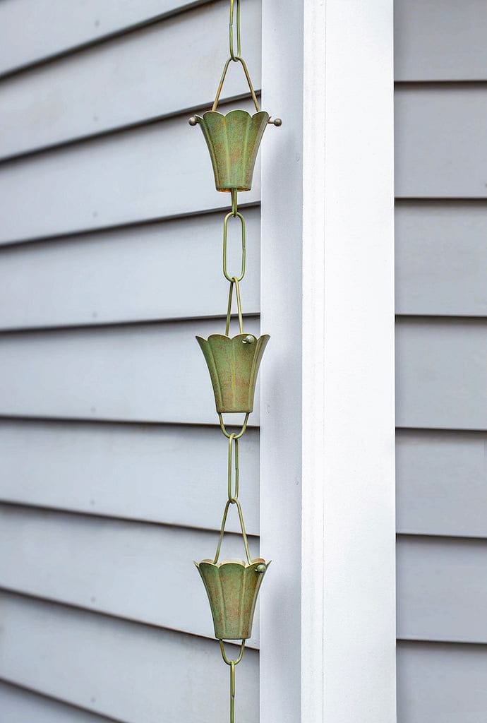 Good Directions Fluted Flower Pure Blue Verde Copper 8.5 ft. Rain Chain beautifully placed on the corner of a home.