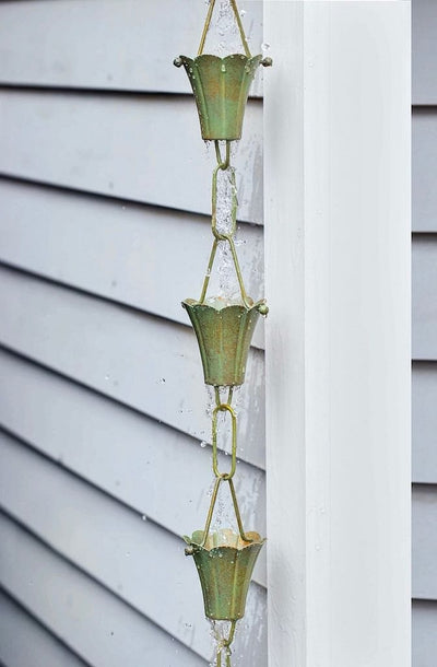 Good Directions Fluted Flower Pure Blue Verde Copper 8.5 ft. Rain Chain links capturing the rain.