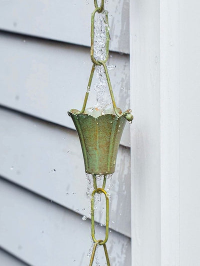 Good Directions Fluted Flower Pure Blue Verde Copper 8.5 ft. Rain Chain capturing the rain.