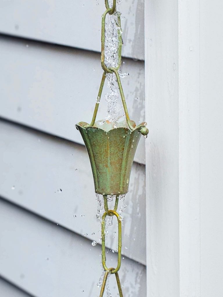 Good Directions Fluted Flower Pure Blue Verde Copper 8.5 ft. Rain Chain capturing the rain.