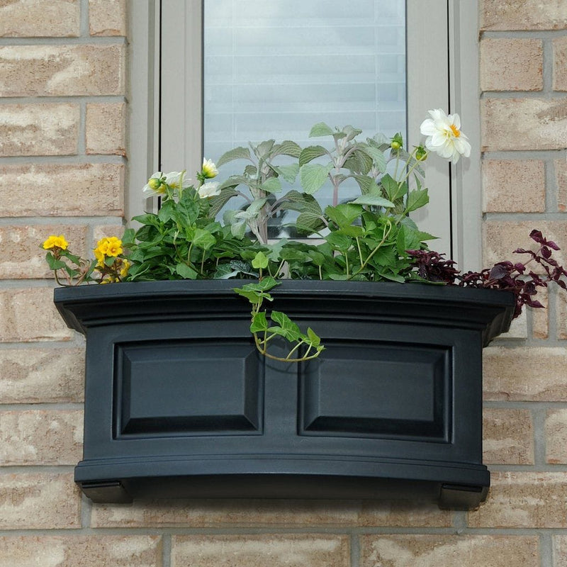 The Mayne Nantucket 2ft Window Box Planter, in the black finish, planted and mounted on home for curb appeal