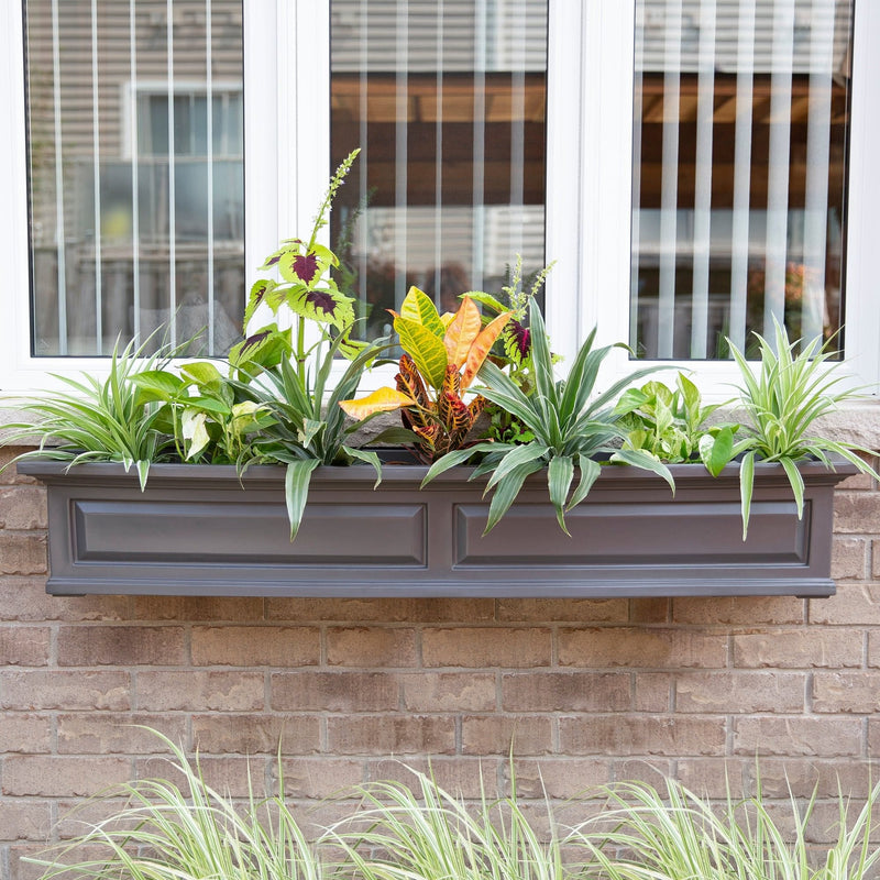 The Mayne Nantucket 5ft Window Box, in the graphite finish,planted and mounted on home for curb appeal