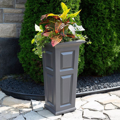 The Mayne Nantucket Tall Planter, in the graphite finish,planted and placed near home for curb appeal.