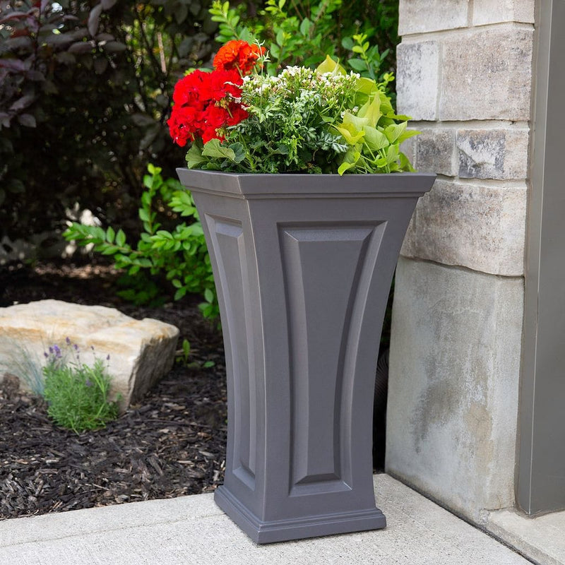 The Mayne Cambridge Tall Planter, in the graphite finish,planted and placed near home for curb appeal.