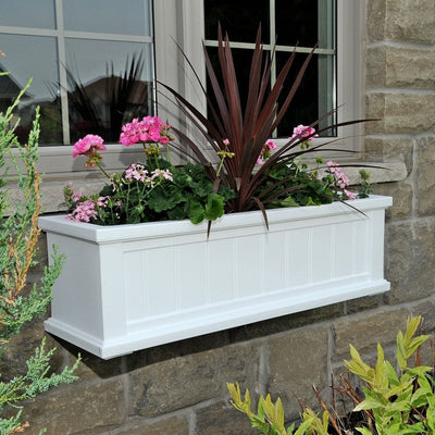 The Mayne Cape Cod 3ft Window Box, in the white finish, planted and mounted on home for curb appeal