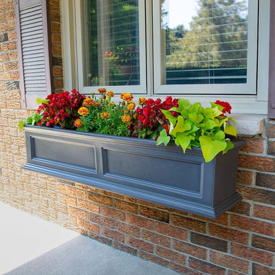The Mayne Fairfield 4ft Window Box Planter, in the graphite finish,planted and mounted on home for curb appeal