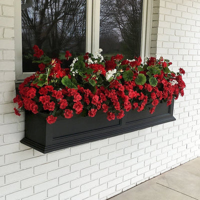 The Mayne Fairfield 5ft Window Box Planter, in the black finish, planted and mounted on home for curb appeal
