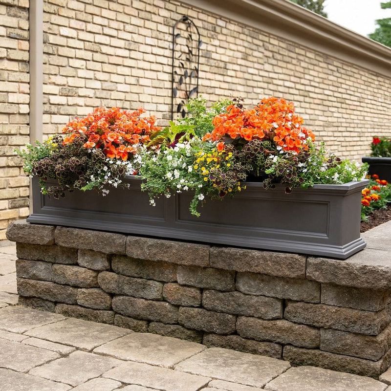 The Mayne Fairfield 5ft Window Box Planter, in the graphite finish,planted and mounted on home for curb appeal