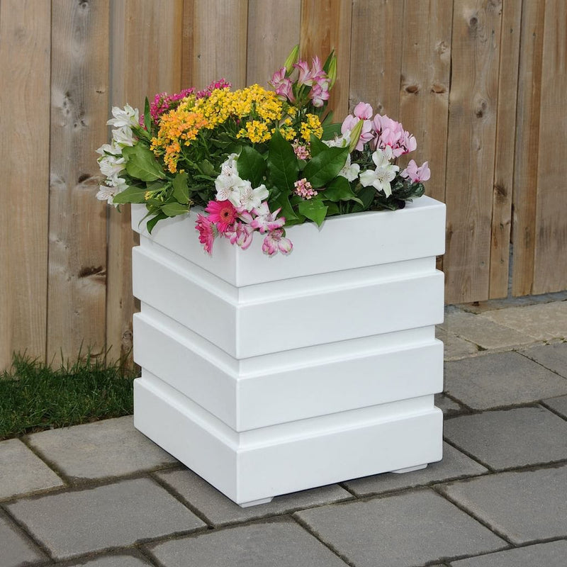 The Mayne Freeport 18x18 Square Planter, in the white finish, planted with colorful flowers to add curb appeal to a front entry of a home.