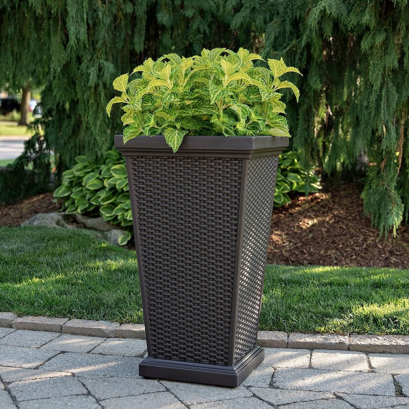 The Mayne Wellington Tall Planter, in the espresso finish, simply planted with flowers to add curb appeal to a front entry of a home.