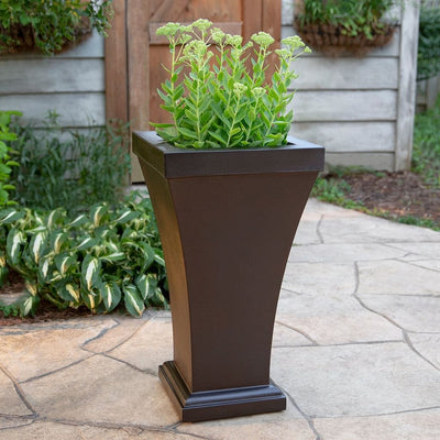 The Mayne Bordeaux Tall Planter, in the espresso finish, planted flowers to add curb appeal to a front entry of a home.