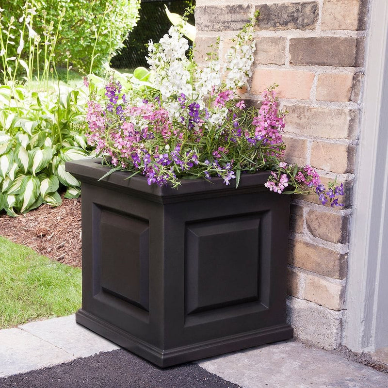 The Mayne Nantucket Square Planter, in the espresso finish, planted with cool season annuals, decorating an entryway