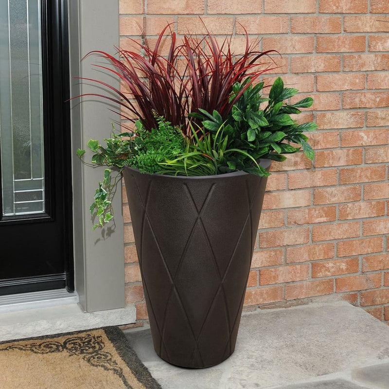 The Mayne Versailles Tall Round Planter, in the espresso finish, filled with a colorful foliage arrangement for curb appeal