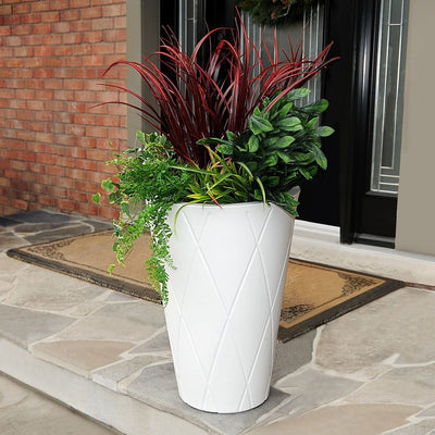 The Mayne Versailles Tall Round Planter, in the white finish, filled with a colorful foliage arrangement for curb appeal