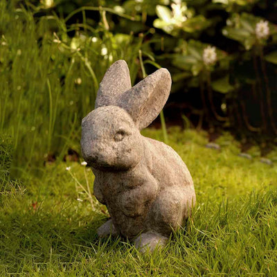 Campania International Rabbit - Ears Up Statue, set in the garden to add charm and character. The statue is shown in the Aged Limestone Patina.