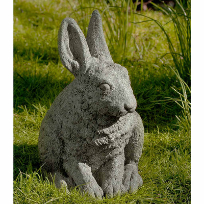 Campania International Hare Seated - Ears Up Statue, set in the garden to add charm and character. The statue is shown in the Alpine Stone Patina.