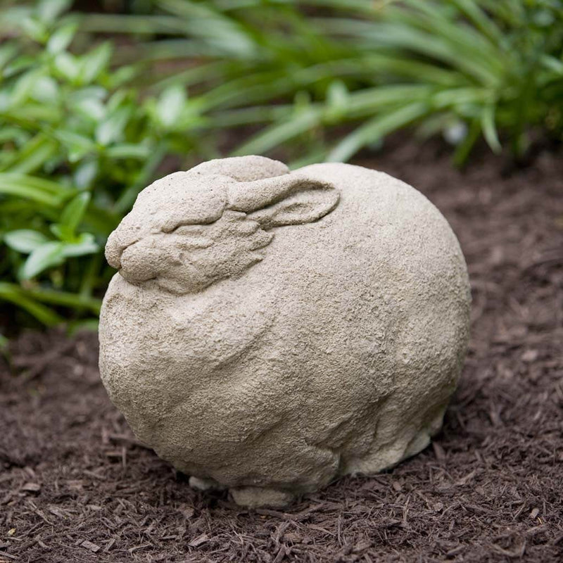 Campania International Fat Rabbit Statue, set in the garden to add charm and character. The statue is shown in the Verde Patina.