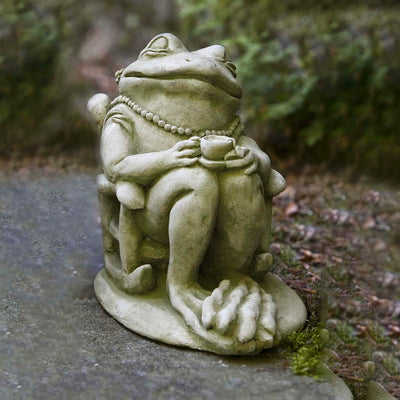 Campania International Tea Statue, set in the garden to add charm and character. The statue is shown in the English Moss Patina.