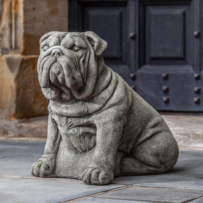 Campania International Antique Bulldog Statue, set in the garden to add charm and character. The statue is shown in the Alpine Stone Patina