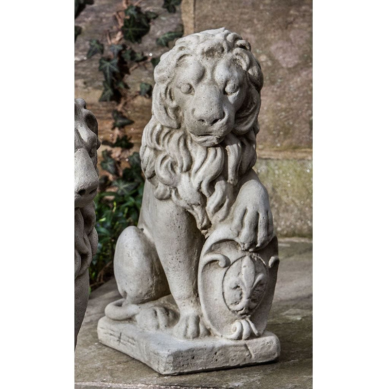 Campania International Small Classic Lion Facing Right Statue, set in the garden to add charm and character. The statue is shown in the Greystone Patina.