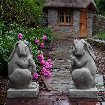 Campania International Newport Rabbit Set Left and Right Statue, set in the garden to add charm and character. The statue is shown in the Greystone Patina.