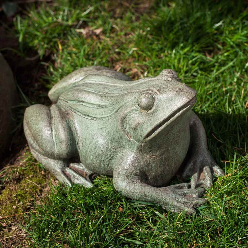 Campania International Woodland Frog Statue, set in the garden to add charm and character. The statue is shown in the Copper Bronze Patina.