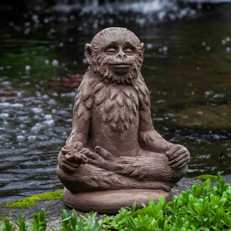 Campania International Doobie Statue, set in the garden to add charm and character. The statue is shown in the Brownstone Patina.
