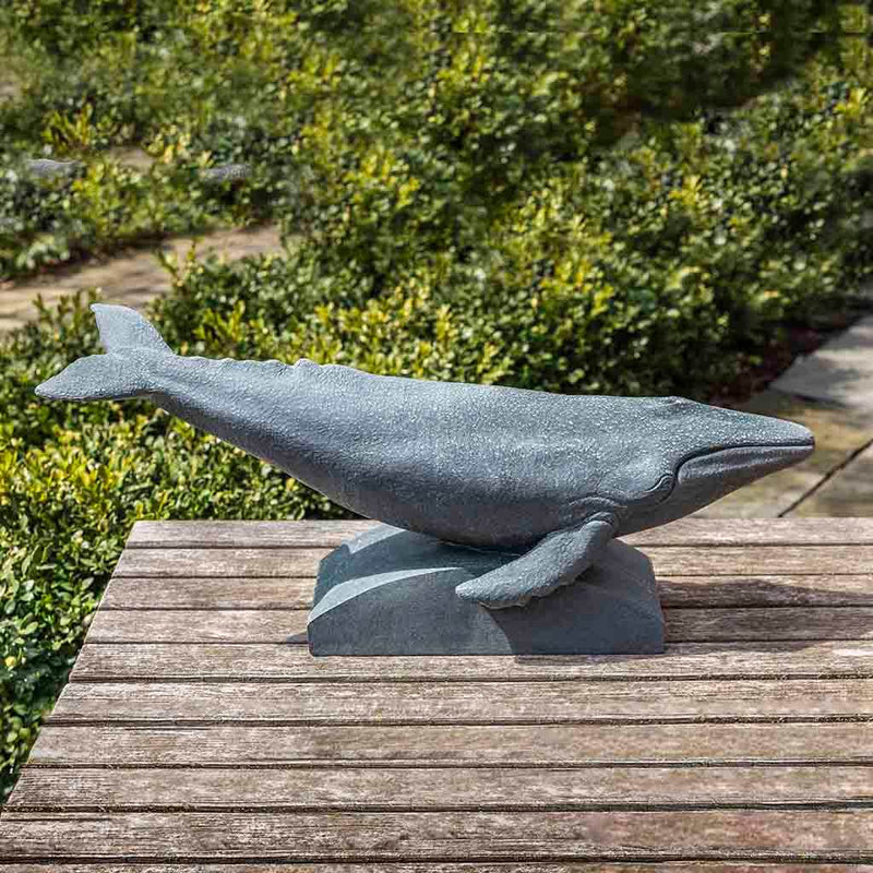 Campania International Humpback Whale Statue, set in the garden to add charm and character. The statue is shown in the Lead Antique Patina.