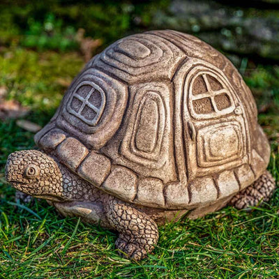 Campania International Traveling Turtle Statue, set in the garden to add charm and character. The statue is shown in the Brownstone Patina.